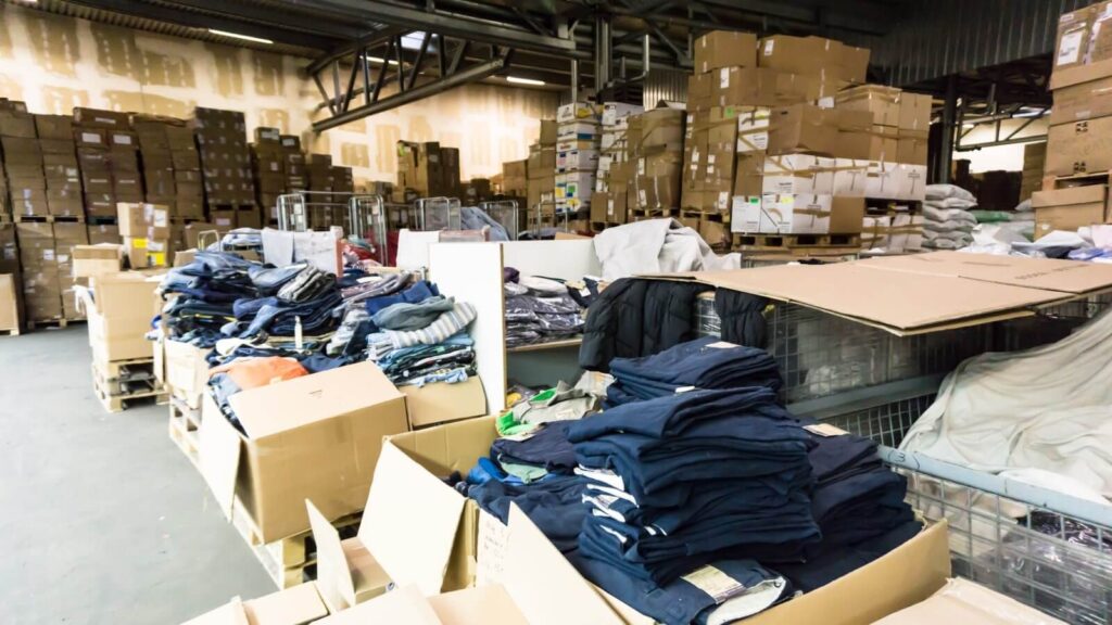 A warehouse with various clothing items.