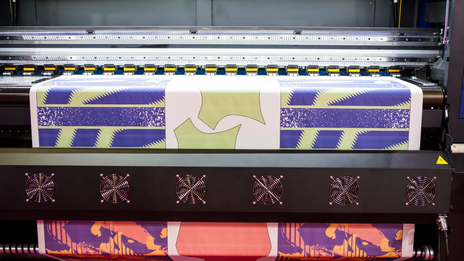 A direct-to-film DTF) printe in the process of printing.