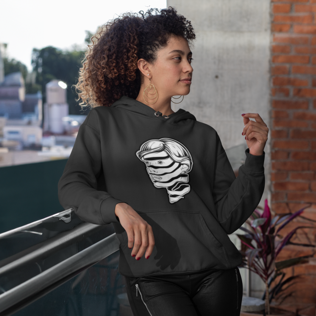 A woman in a dark green hoodie with an abstract art print of a woman's head.