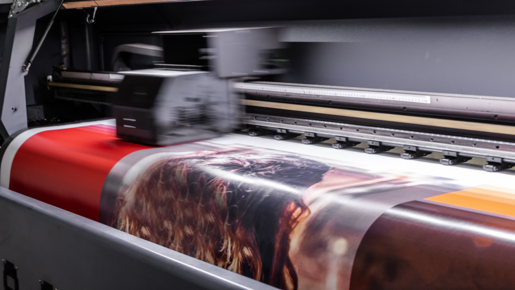 A printing machine printing a poster.