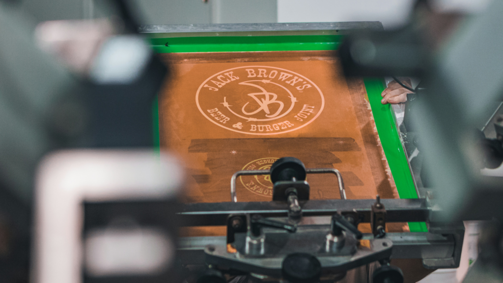 The process of custom t-shirt printing using screen printing.